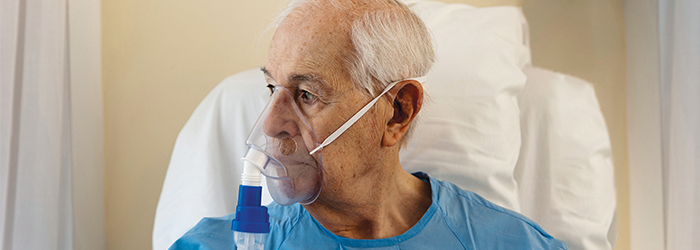 Patient in bed with oxygen mask