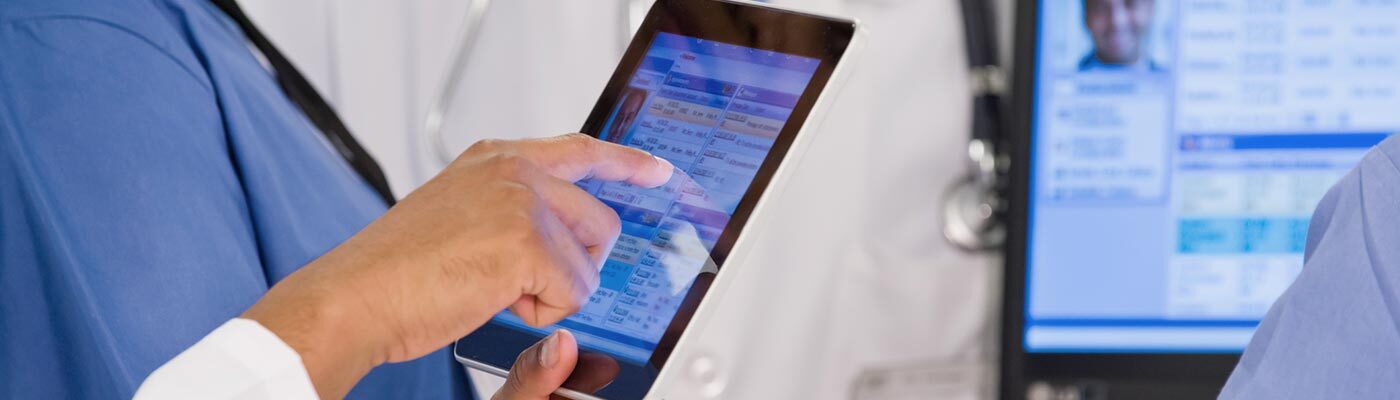 Clinicians review patient information on a tablet