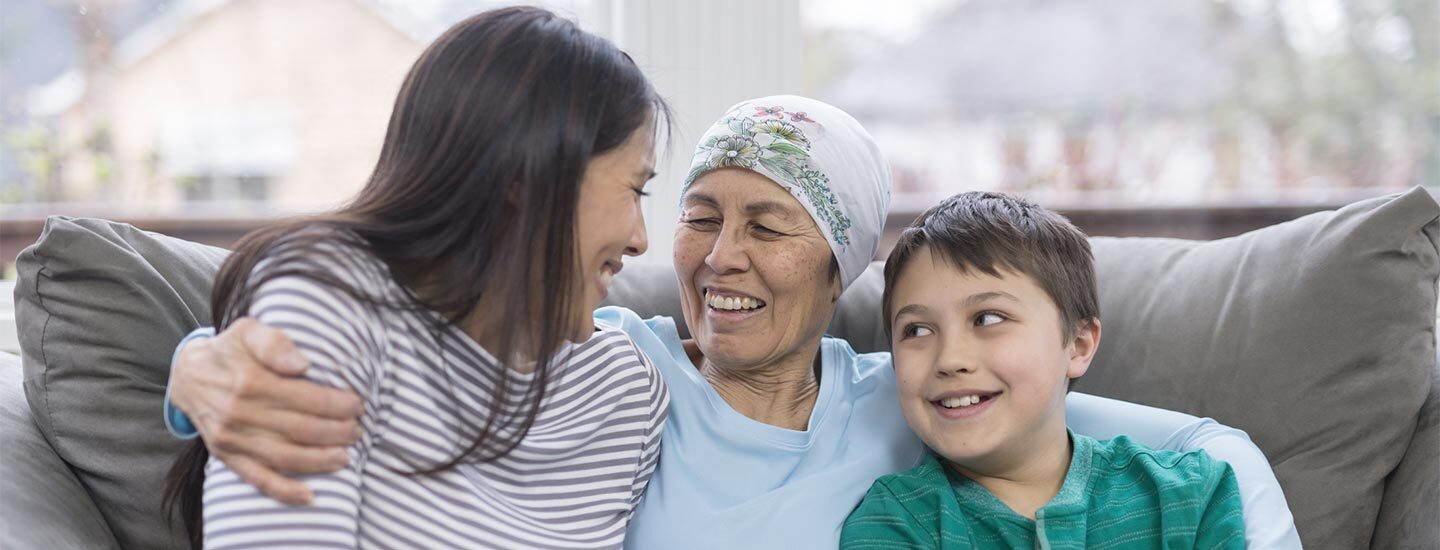 A woman with cancer at home with her daughter and grandson