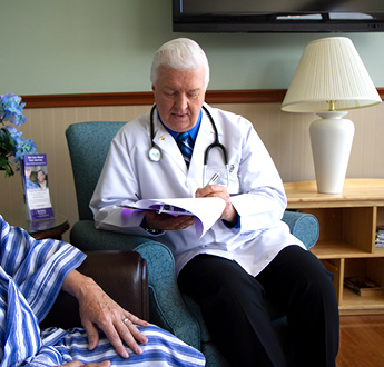 A physician talks with a patient in an office