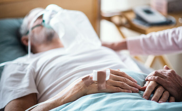 A physician talks on his cellphone at his desk