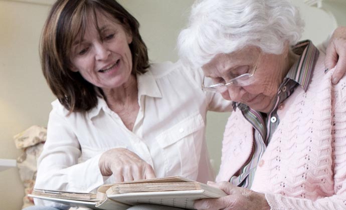 A caregiver reads with a loved one