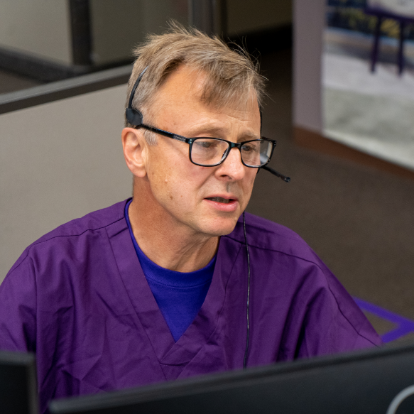 A VITAS team member speaks with a caregiver on the phone