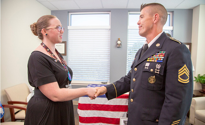 A VITAS team member shakes hands with a military veteran